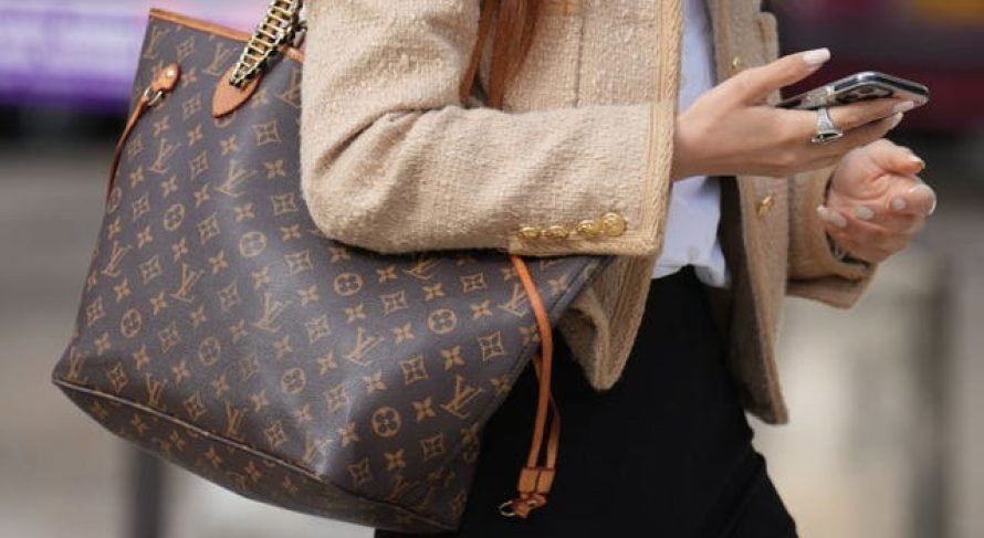 guest-wears-a-beige-tweed-jacket-a-vuitton-large-bag-black-news-photo-1717673948